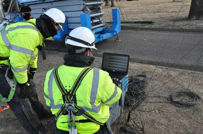 Two people checking bridge health data