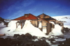 Mawson’s Hut, an Australian symbol of the Heroic Era of Antarctic Exploration, sits on Cape Denison, Commonwealth Bay, a site recognized as the windiest place on earth at sea level. (Photo courtesy of Steve Martin, State Library, NSW)