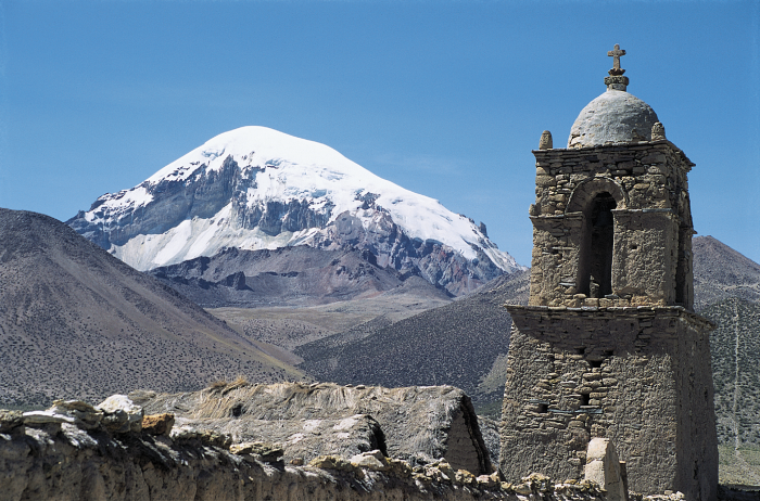 Framed by a church built c. 1886, Nevado Sajama (21,464 ft above sea level) rises behind the village of Sajama in western Bolivia. Ice cores taken from the summit detail global-scale changes in climate.