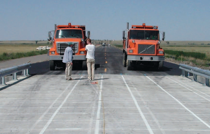 Researchers prepare for a two-truck live load test in order to reach one of the objectives of the Montana highway project, which is to compare load-carrying mechanisms of three different bridge decks near Saco.